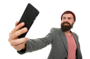 His best selfie is yet to come. Bearded man smiling to selfie camera. Happy hipster taking selfie with smartphone in hand. Perfect selfie from any angle