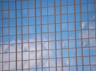Business center. Glass facade background blue sky reflection. Modern architecture. Construction and design. Commercial property or real estate. Real estate concept. Sale and purchase of buildings
