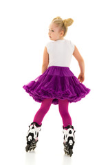 Little girl on roller skates.