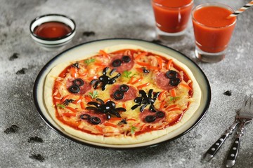 Cute pizza with olives and sausage spider for Halloween party. Children's food. 