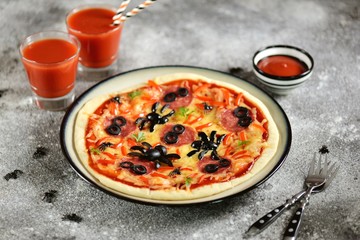 Cute pizza with olives and sausage spider for Halloween party. Children's food. 