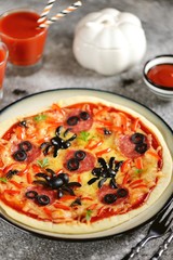 Cute pizza with olives and sausage spider for Halloween party. Children's food. 