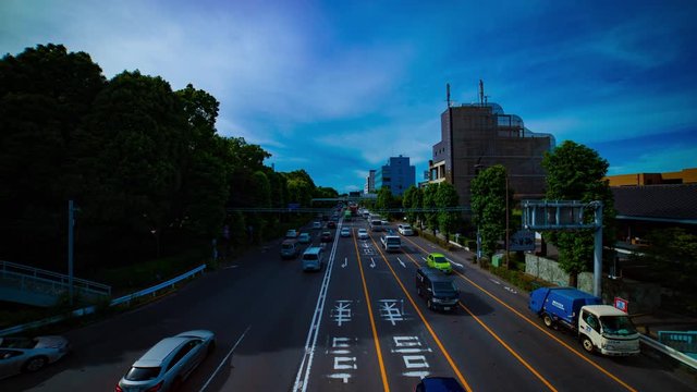 A timelapse of downtown street at Kanpachi avenue in Tokyo daytime wide shot tilt