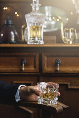 Male hand with a glass of expensive whiskey