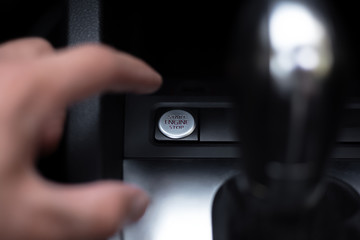 Close-up of male hand, presses start and stop engine button in the car.