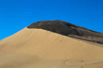 Fototapeta na wymiar Golden sands of a singing dune in Kazakhstan