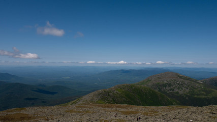 Fototapeta na wymiar View of the White Mountains from Mount Washington summit. Vast mountain range on a sunny day