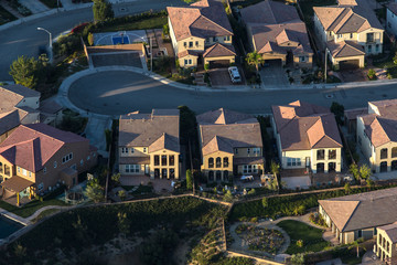 Aerial afternoon view of suburban homes on cul-de-sac street in the San Fernando Valley area of Los Angeles, California.