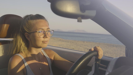 Naklejka premium Woman Driving Car By The Sea