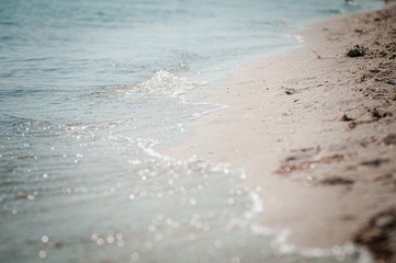 Fototapeta na wymiar sea wave washes the sandy shore