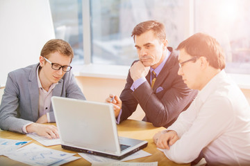 three businesspeople interacting at meeting