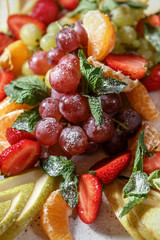 Fruit slicing, grapes sprinkled with powdered sugar