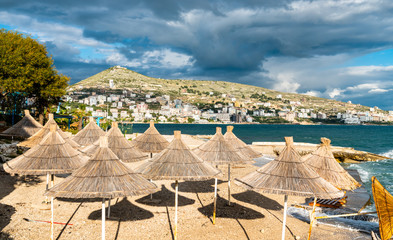 Straw umbrellas on a beach in Saranda, Albania
