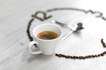Coffee beans folded in the form of a clock. Instead of the number 9, a cup of coffee, which means it's time to drink coffee