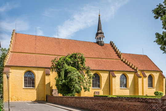A yellow church against blue sky in Faaborg Denmark