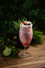  Berry refreshing smoothie with cream on a green background