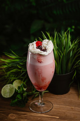  Berry refreshing smoothie with cream on a green background