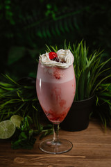  Berry refreshing smoothie with cream on a green background