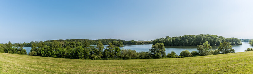 a panoramic landscape with fields and lakes in Denmark
