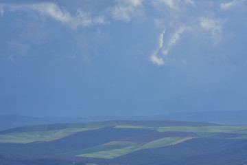 distant mosaic of cultivated fields in late winter