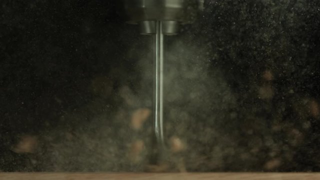 Slow motion close up, wood milling drill bit carves wood