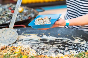 Person using a large ladle to serve a savory pie