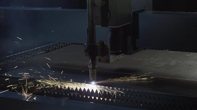 CNC machine cuts through metal, spark fly