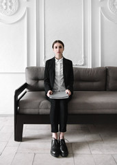 Get job Waiting for an interview Young woman in a business suit is sitting in the lobby while she waiting for an interview