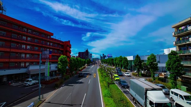 A timelapse of downtown street at Kanpachi avenue in Tokyo daytime wide shot zoom