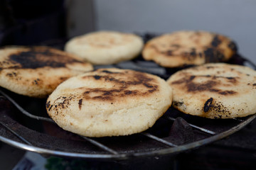 arepas pver the grill open fire