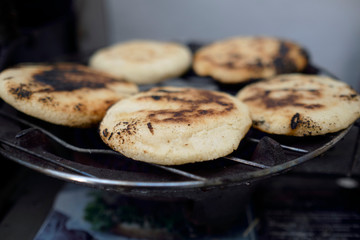 arepas pver the grill open fire