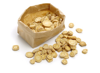 Chinese Herbal medicine - Astragalus slices, Huang Qi (Astragalus propinquus) on white background 