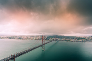 April 25th bridge as seen from National Sanctuary of Christ the King viewpoint in Lisbon, Portugal.