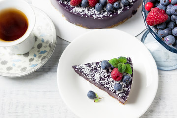 Vegan raw cake with raspberries and blueberries.  Healthy vegan food concept. Sugar, dairy and gluten free dessert.