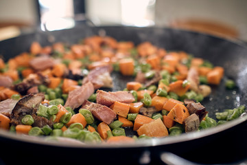 preparation of rice with chicken in Latin style with vegetables, broccoli, peas, carrots, white rice