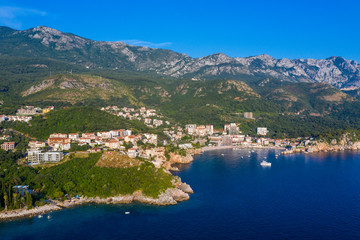 Fototapeta na wymiar Aerial panoramic landscape of Budva Riviera, Montenegro. Scenic view of the coastline of Becici and Rafailovici on the Adriatic Sea on a summer day.