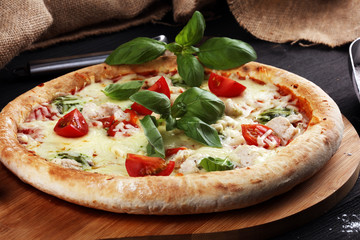 vegetarian italian Pizza with tomatoes, mozzarella cheese  and basil. Delicious italian pizza