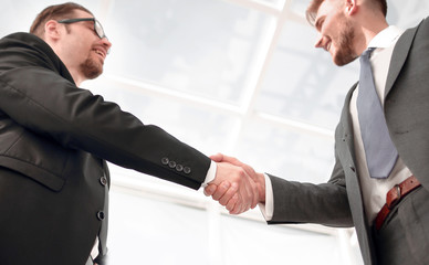 bottom view.smiling business people shaking hands