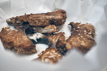 golden fried fish, is swordfish on white napkins on a white plate