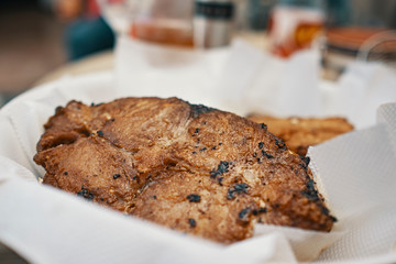golden fried fish, is swordfish on white napkins on a white plate