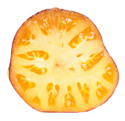Ripe yellow tomato cut in half inside cross section isolated on white background