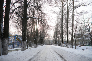A man walks through the city on snowy winter day.