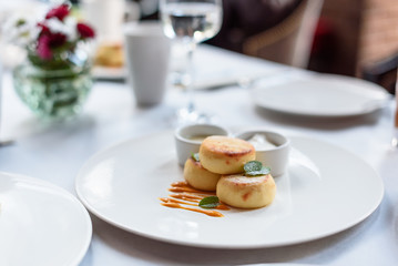 Cottage cheese pancakes with caramel sauce. Brunch in restaurant