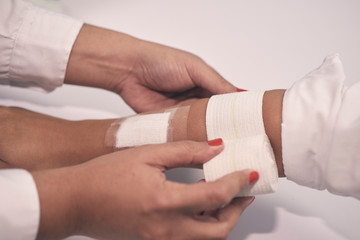 a woman's arm is bandaged with a white bandage and a first aid aid
