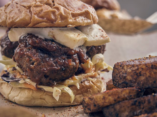 Cheese and meat stuffed burgers with cabbage salad served on the table
