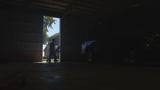 Caucasian father and son opening barn door