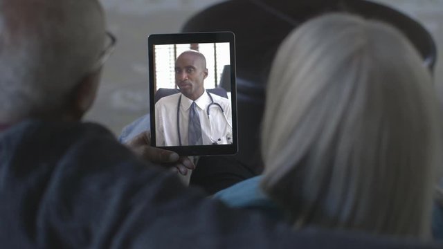 Black couple video chatting with doctor