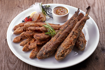 Fried fish on a white plate, on a board. Bulls, Barabola