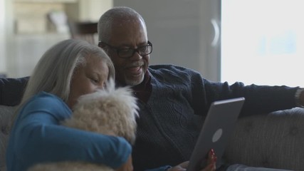 Black couple video chatting on digital tablet