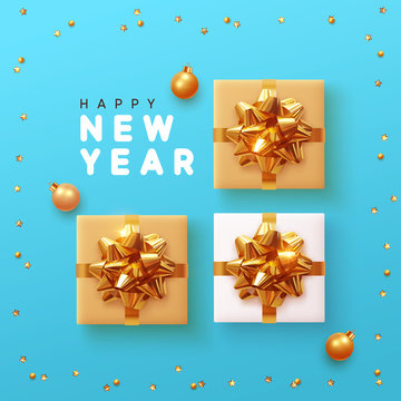 Happy New Year background with gift box, golden bright stars and gold balls, Xmas bauble. Christmas realistic gift presents view top.